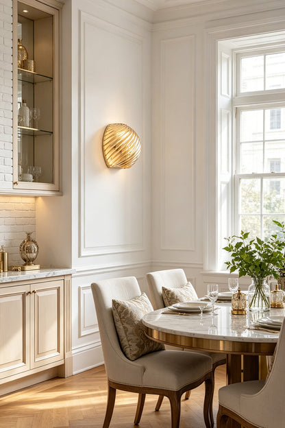 Silas Ribbed Glass Wall Sconce | Ribbed Glass, Metal | Installed as sophisticated ambient lighting in a refined classical dining room casting a warm gold glow next to a table set | vexa lamps