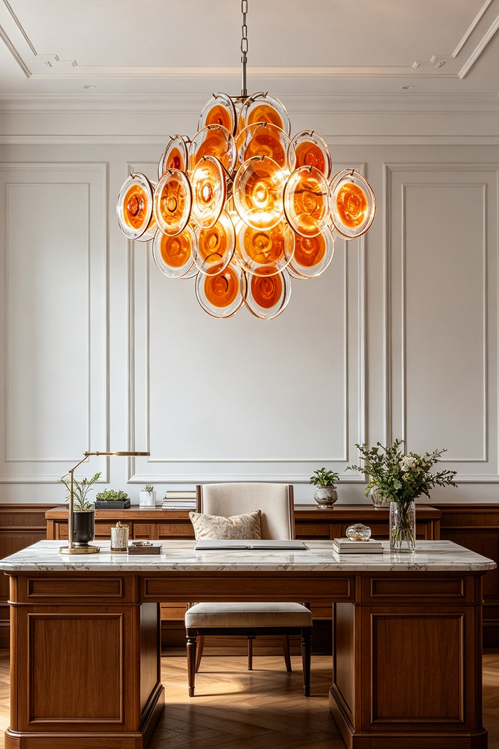 Grand Solari Amber Glass Chandelier | Metal, Glass | Centered view in a luxury study over a white-top desk | vexa lamps