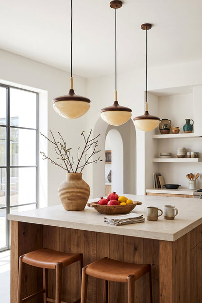 Soren Wood Grain Pendant Lamp | Wood, Glass, Metal | A trio of wood and glass pendant lamps casting a warm glow over a rustic wooden kitchen island | vexa lamps