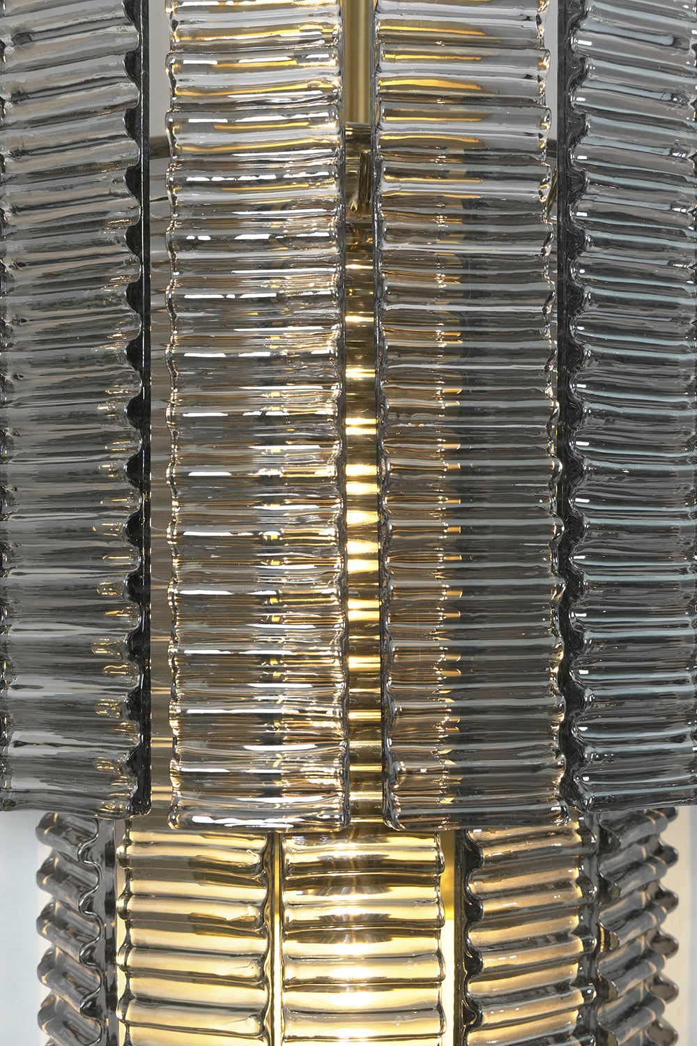 Sovereign Lattice Smoky Glass Wall Lamp featuring ribbed smoky gray glass links and illuminating design.
