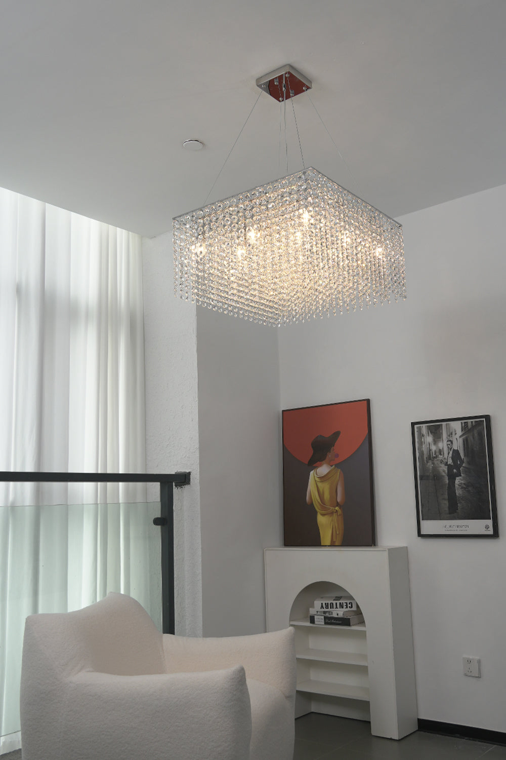 Modern crystal chandelier in a high-ceiling living area | Stainless Steel, Crystal | Interior scene with contemporary art and white furniture | vexa lamps