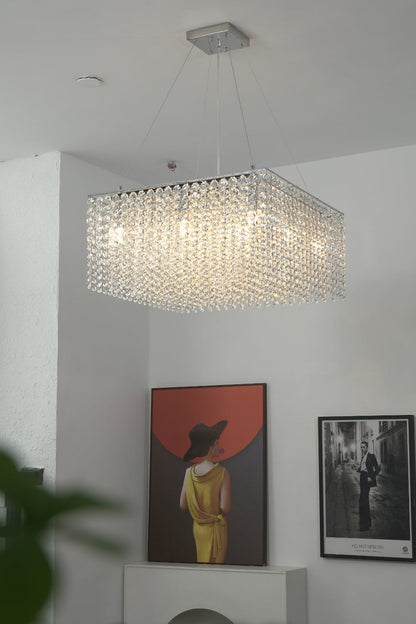 Rectangular crystal pendant light providing bright illumination | Stainless Steel, Crystal | Mounted in a room with modern paintings | vexa lamps