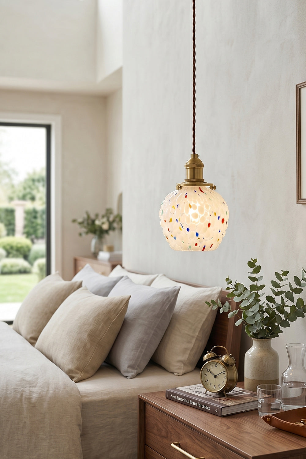 Speckled Bubble Glass Pendant Lamp | Glass, Metal | Hanging as a cozy bedside reading lamp over a wooden nightstand in a soft, cream-toned modern bedroom | vexa lamps