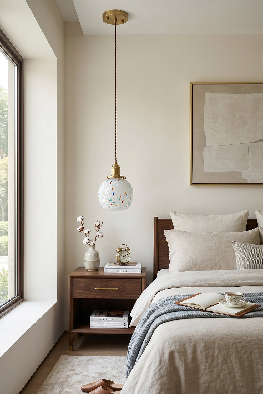 Speckled Bubble Glass Pendant Lamp | Glass, Metal | Positioned near a large bedroom window, providing soft light over a dark wood bedside table | vexa lamps