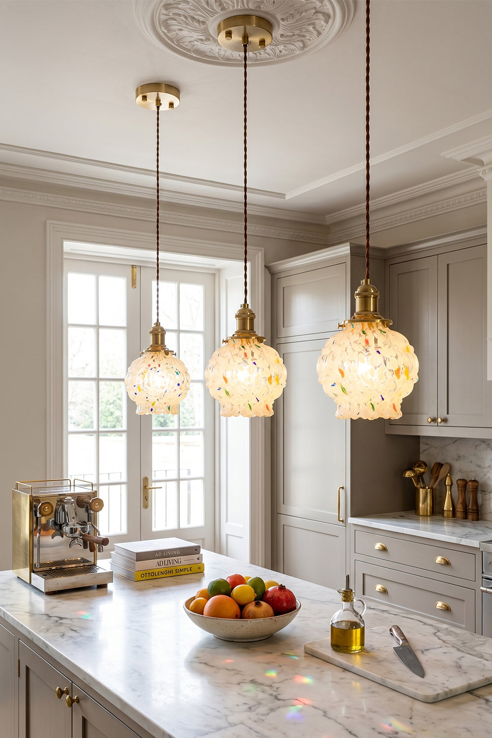 Speckled Bubble Glass Pendant Lamp | Glass, Metal | Three speckled glass pendant lights providing a warm, inviting glow over a clean white marble kitchen counter | vexa lamps
