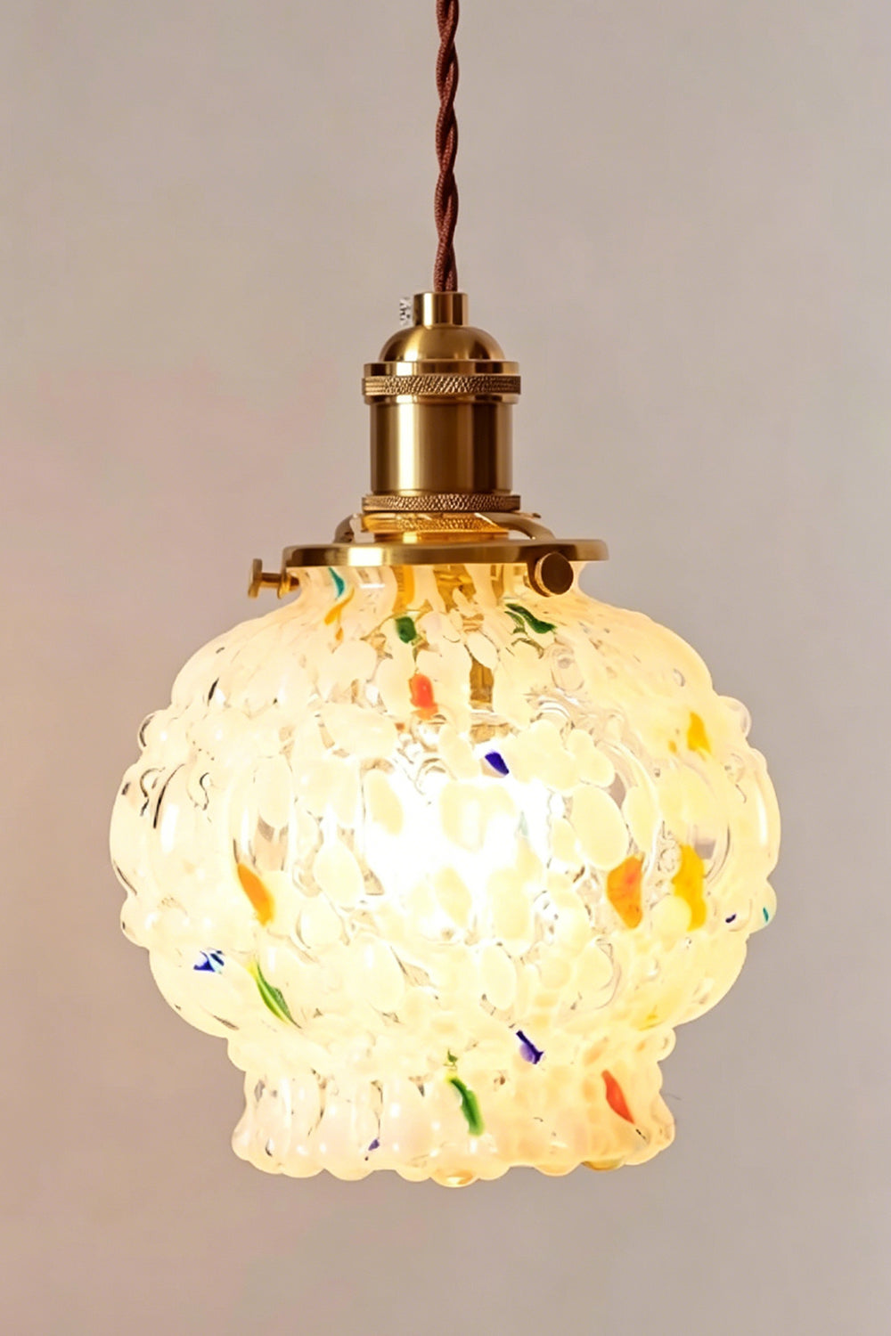 Speckled Bubble Glass Pendant Lamp | Glass, Metal | Detailed shot of the fully illuminated speckled glass shade radiating a warm, textured yellow glow | vexa lamps