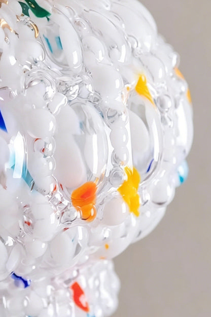 Speckled Bubble Glass Pendant Lamp | Glass, Metal | Macro close-up of the bumpy bubble glass texture embedded with colorful red, orange, and blue glass chips | Detail shot | vexa lamps