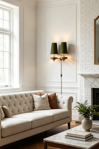 Spindle Walnut Wood Wall Sconce illuminating a stylish living room with a tufted sofa and green accent lampshades.