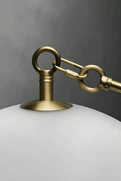 Detailed shot of brass hook and glass attachment | Metal, Glass | Showing the gold-finish hardware connection | vexa lamps