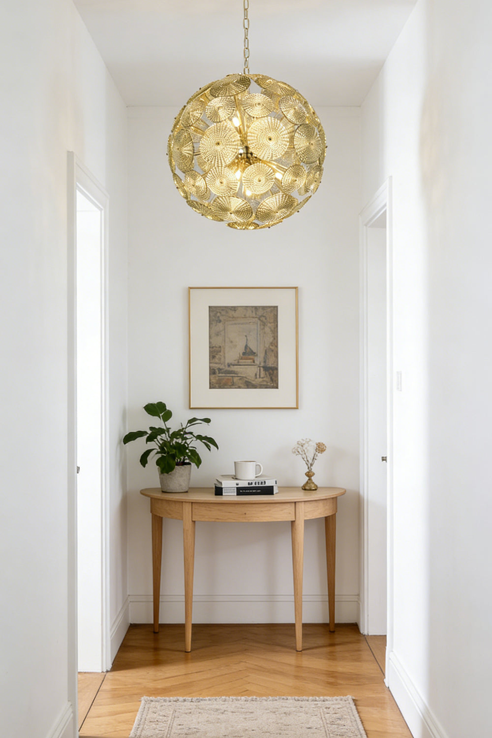 Lit modern classic spheres chandelier | Metal, Glass | Installed at the end of a corridor over a console table | everlamps