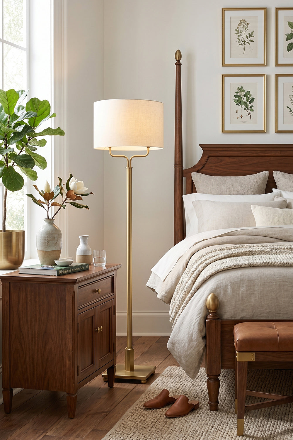 Sutton Modern Brass Floor Lamp beside a wooden bed and nightstand in a cozy bedroom setting.