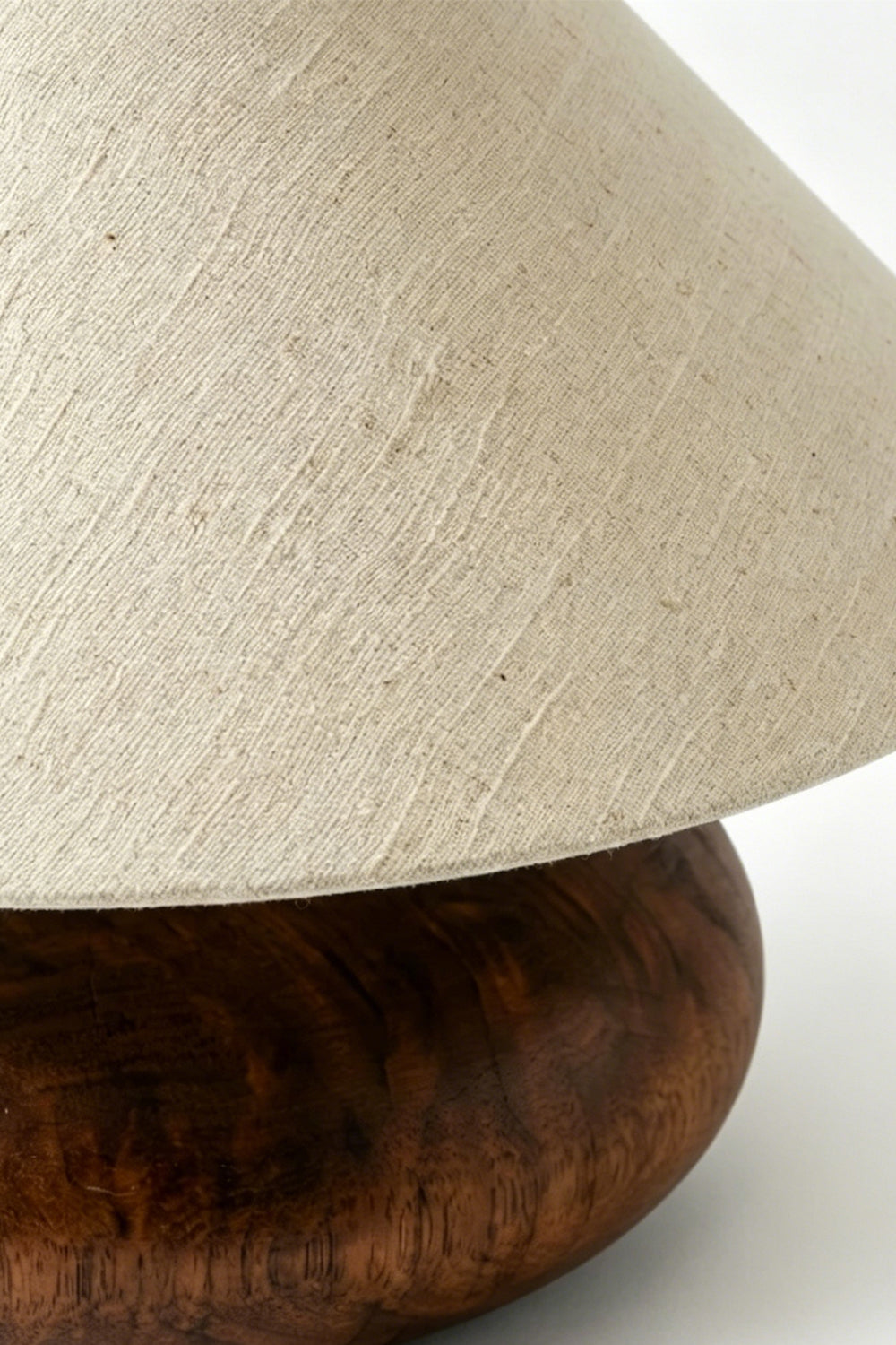 Sylvan Oval Walnut Table Lamp | Wood, Fabric, Metal | Close-up side view showcasing the sleek interface between the fabric shade and walnut wood base | Detail shot | vexa lamps Sylvan Oval