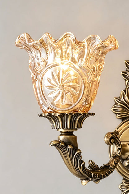Sylvestre Petal Glass Brass Wall Lamp with an elegant pink glass shade featuring detailed floral design.