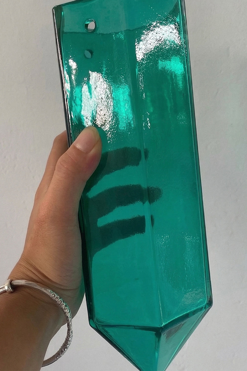 Individual teal glass prism detail | Glass | Handheld view showing material transparency and scale | vexa lamps