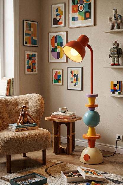 Tectonic Prism Metal Floor Lamp | Metal | Set against a gallery wall with colorful abstract art and a beige armchair | vexa lamps