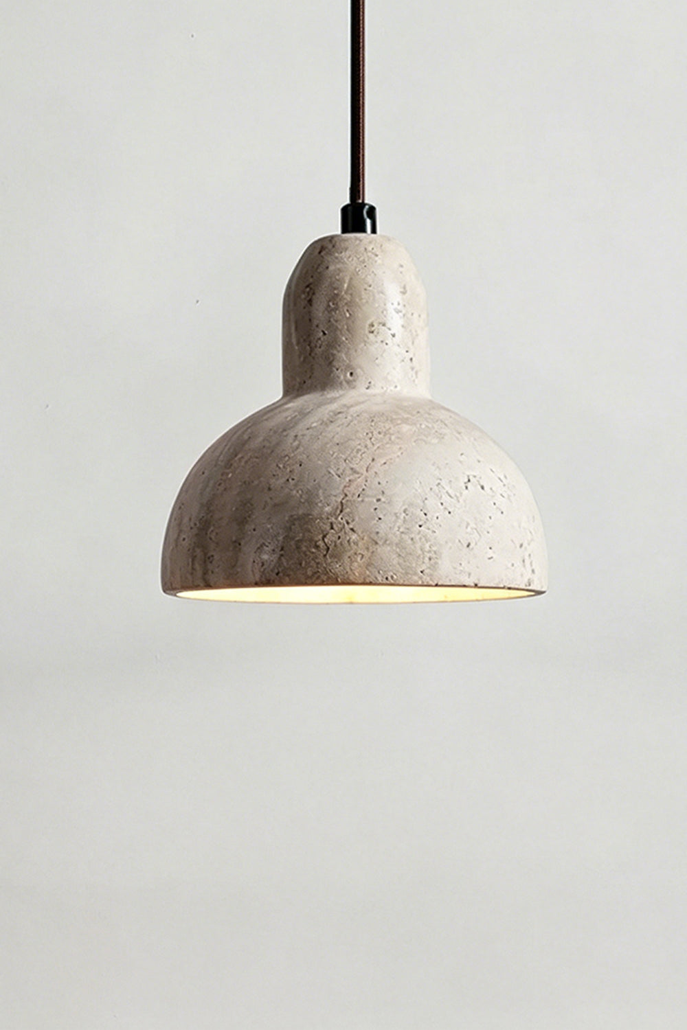 Lit Beige Travertine Pendant Light | Beige Travertine, Metal, Glass | Close-up showing warm upward and downward glow | vexa lamps
