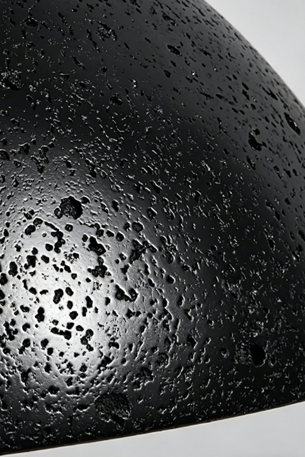 Tectonic Vein Travertine Detail | Black Travertine | Close-up of porous stone texture and rough veining | vexa lamps