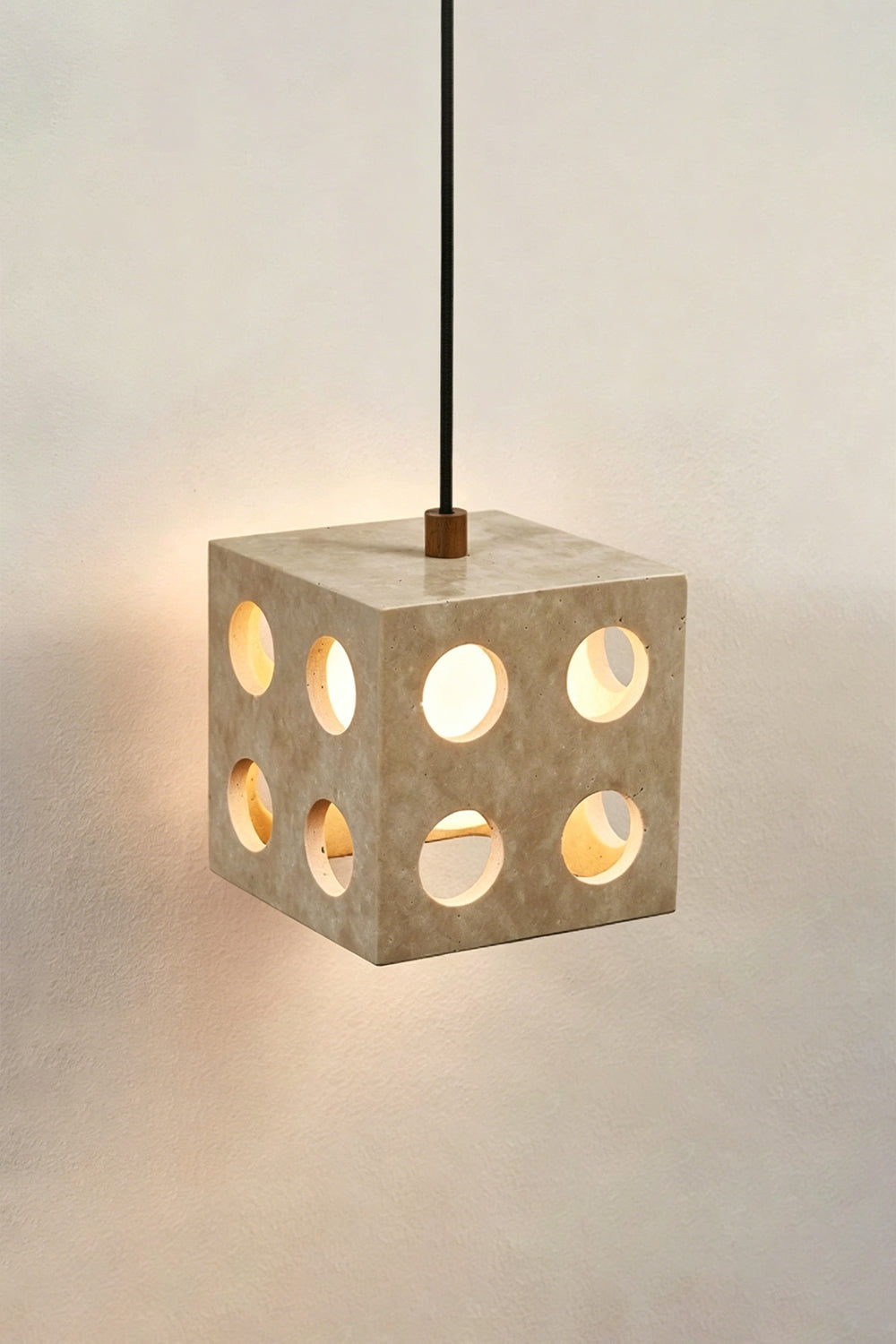Terra Cube Travertine Pendant Light | Travertine, Metal | Lit product view showing light patterns against a wall | vexa lamps