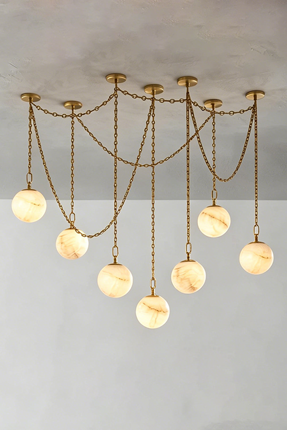 Thalia Alabaster Spherical Chain Chandelier with hand-carved alabaster spheres and brushed links.