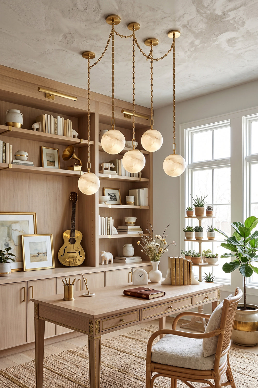 Thalia Alabaster Spherical Chain Chandelier hanging over a modern workspace with bookshelves and a desk.