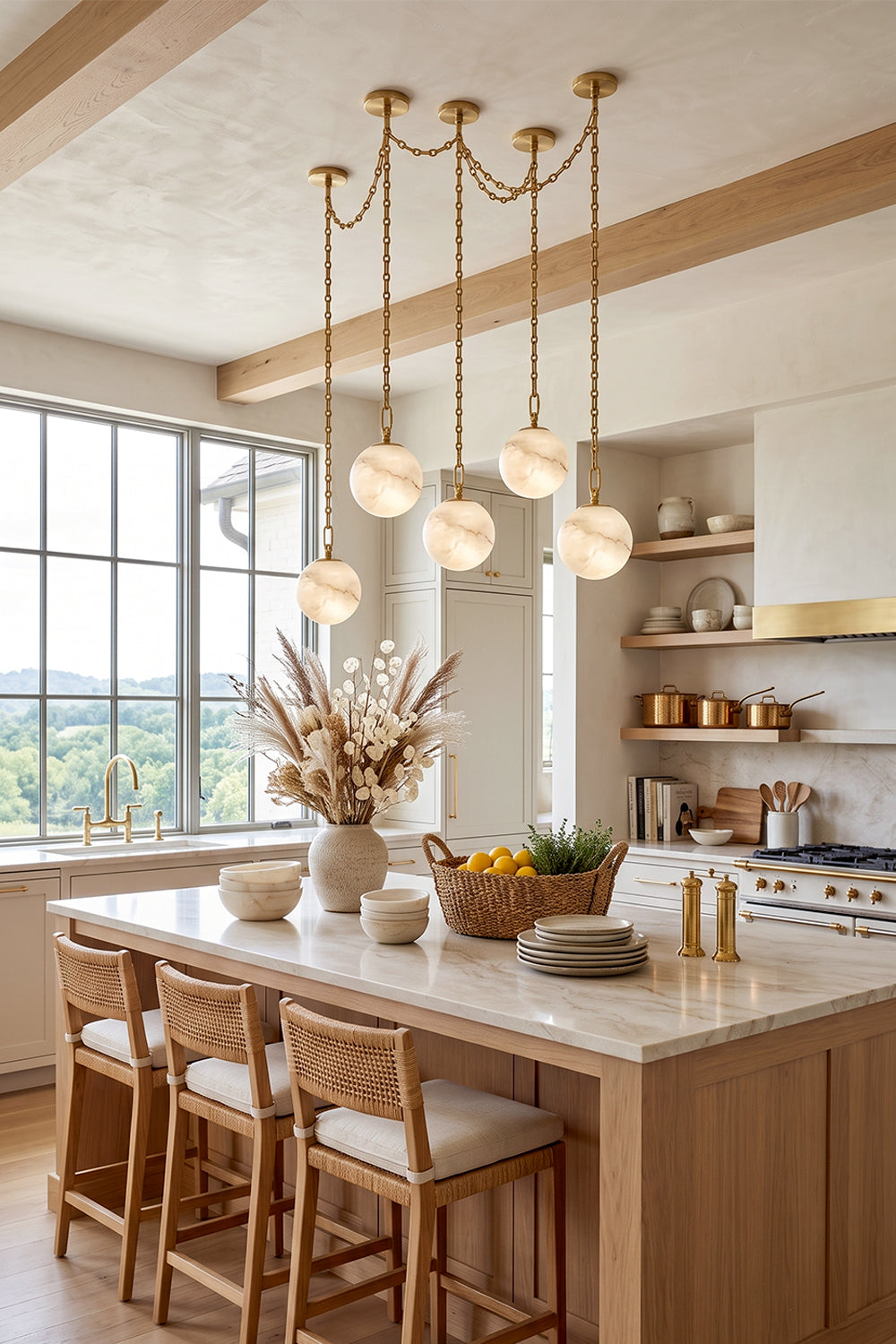Thalia Alabaster Spherical Chain Chandelier illuminating a modern kitchen with natural light and decor.