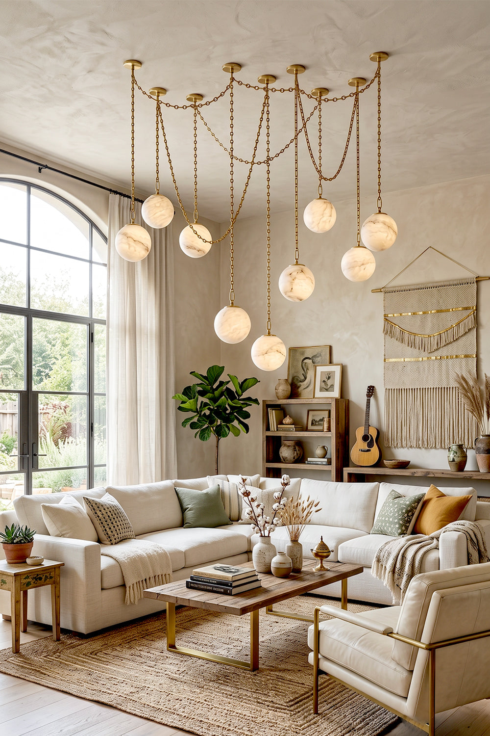 Thalia Alabaster Spherical Chain Chandelier with hand-carved alabaster spheres and brushed gold links in stylish living room.