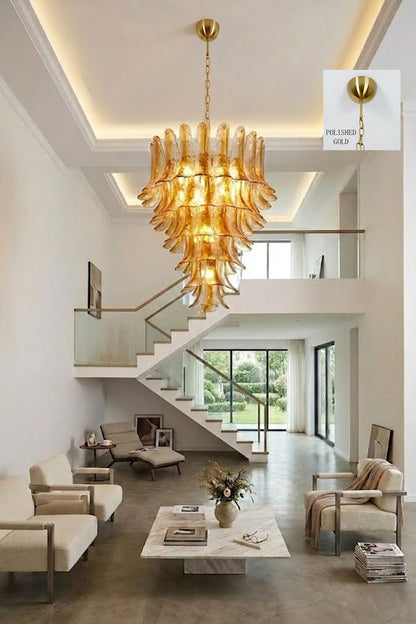 Amber lily glass chandelier in two-story hallway | Metal, Glass | Grand interior view showing the stairs and seating | vexa lamps