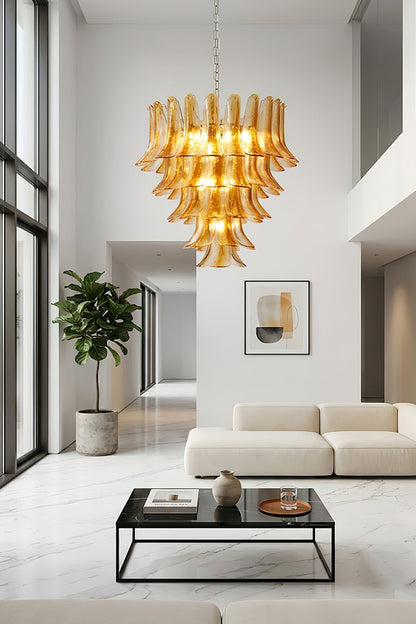 Statement amber lily chandelier in a high-ceiling home | Metal, Glass | Wide shot of a contemporary open-plan interior | vexa lamps