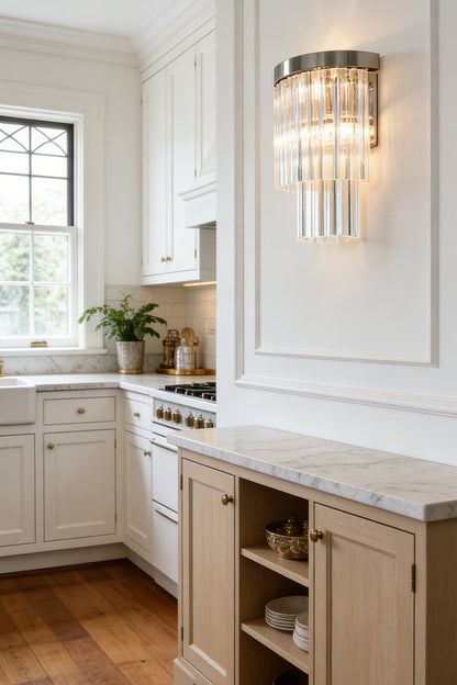 Lit tiered column glass wall light | Metal, Glass | Dining room scene above white wainscoting near a table | everlamps