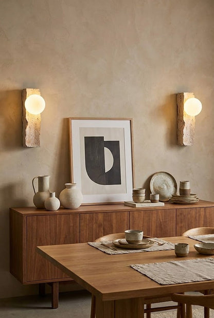 Pair of travertine wall lights in a dining room | Yellow Travertine, Metal, Glass | Flanking a wooden sideboard and dining set | vexa lamps