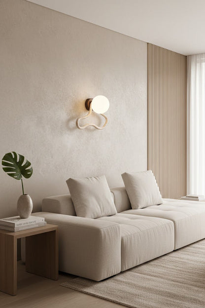 Travertine flow wall sconce in a contemporary living room | Travertine, Glass, Wood | Interior scene with a beige sofa and wooden table | vexa lamps