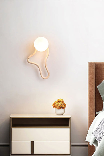 Sculptural travertine wall light in a serene bedroom | Travertine, Glass, Wood | Bedside installation with minimalist furniture | vexa lamps