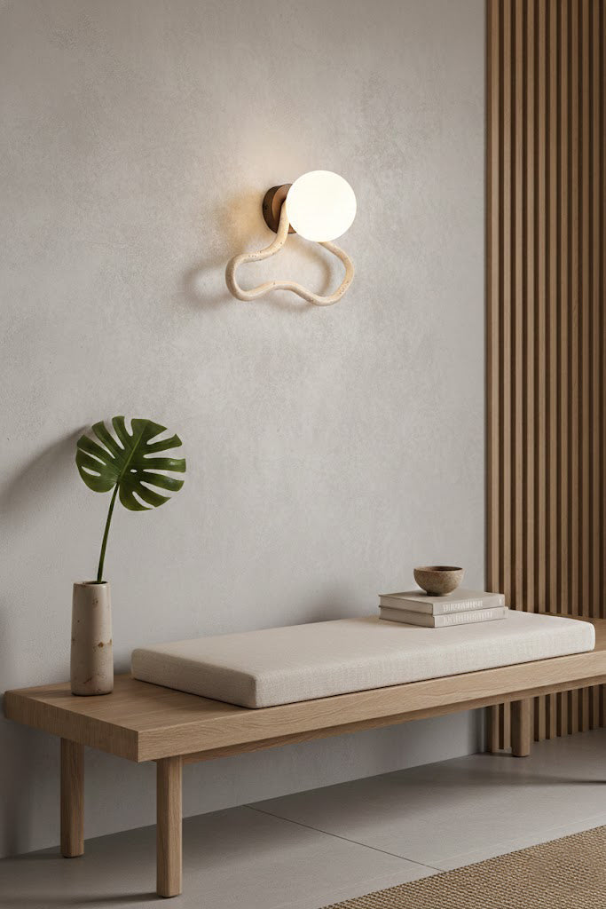 Travertine flow sconce in a zen-inspired space | Travertine, Glass, Wood | Above a wooden bench on a textured wall | vexa lamps
