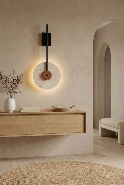 Vertical travertine wall lamp in a minimalist home | Travertine, Wood, Metal | Above a light wood console near an arched doorway | vexa lamps