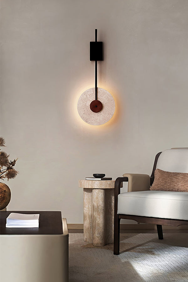 Sculptural travertine wall light in a neutral living room | Travertine, Wood, Metal | Interior scene with a modern side table and chair | vexa lamps