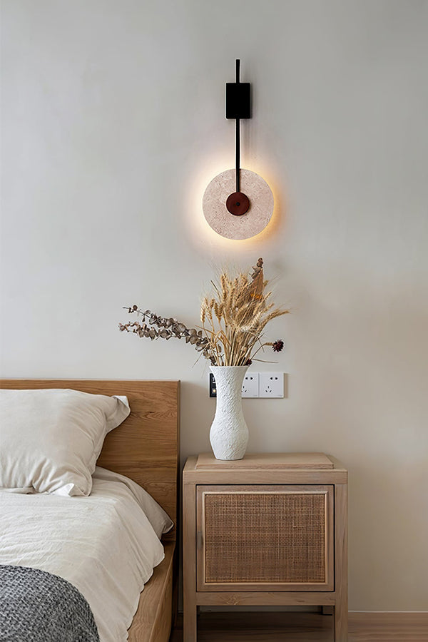 Travertine halo wall light as a bedside lamp | Travertine, Wood, Metal | Mounted above a light wood nightstand | vexa lamps