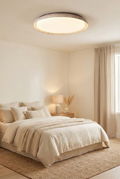 Modern travertine flush mount light in a cozy bedroom | Wood, Travertine, Acrylic | Installed over a neutral-toned bed with warm lighting | vexa lamps