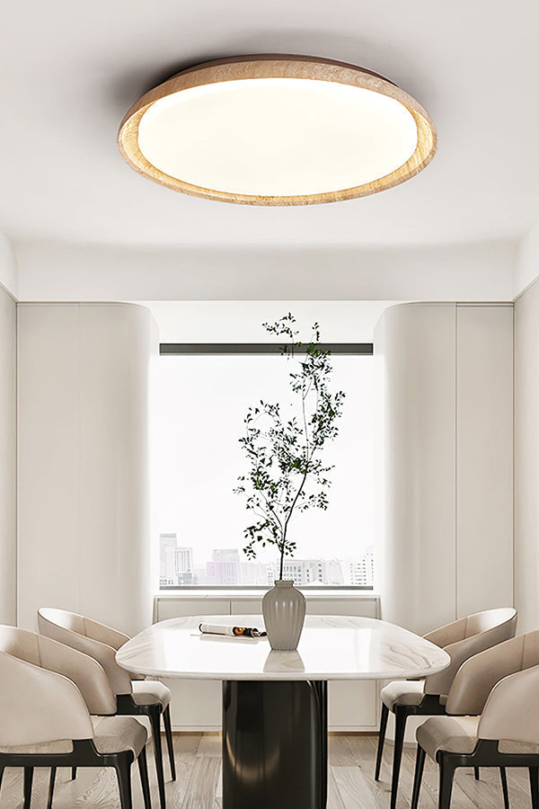 Travertine flush mount light in a minimalist dining area | Wood, Travertine, Acrylic | Above a white dining table with a potted plant | vexa lamps