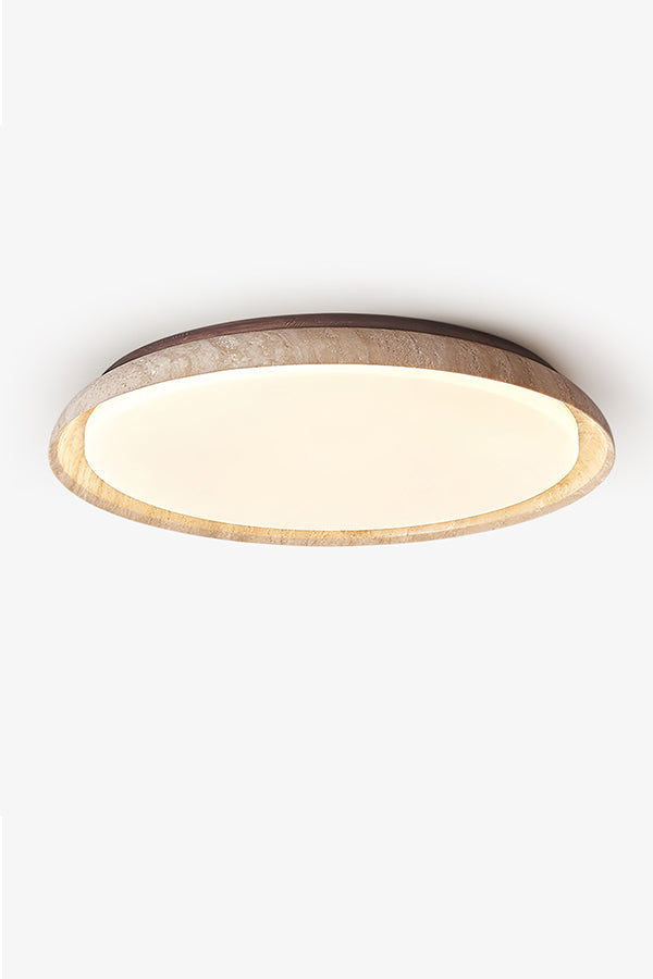 Front view of lit round travertine flush mount light | Wood, Travertine, Acrylic | Focused on the warm even diffusion and stone texture | vexa lamps