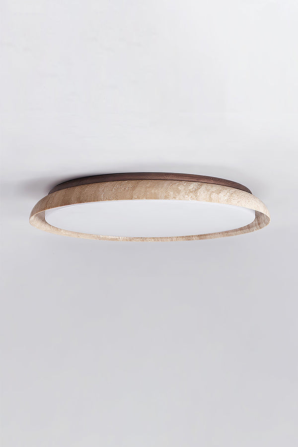 Lit round travertine flush mount lamp against white ceiling | Wood, Travertine, Acrylic | Showing the warm glow and natural stone grain | vexa lamps