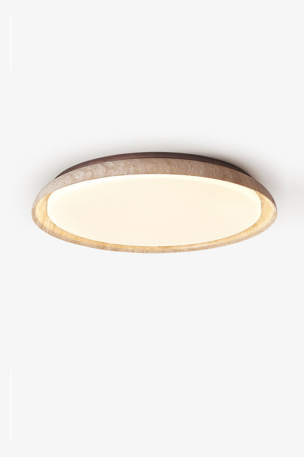 Lit round travertine flush mount lamp against white ceiling | Wood, Travertine, Acrylic | Showing the warm glow and natural stone grain | vexa lamps