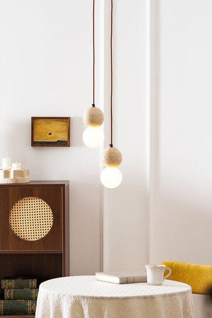 2-light cluster travertine pendant over a cafe table | Yellow Travertine, Glass | Warm lighting in a modern organic interior | vexa lamps