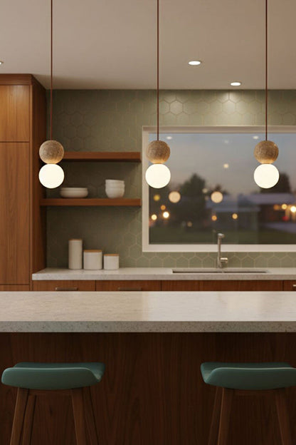 Modern travertine and glass pendant lights | Yellow Travertine, Glass | 3-light cluster over a kitchen bar with green stools | vexa lamps