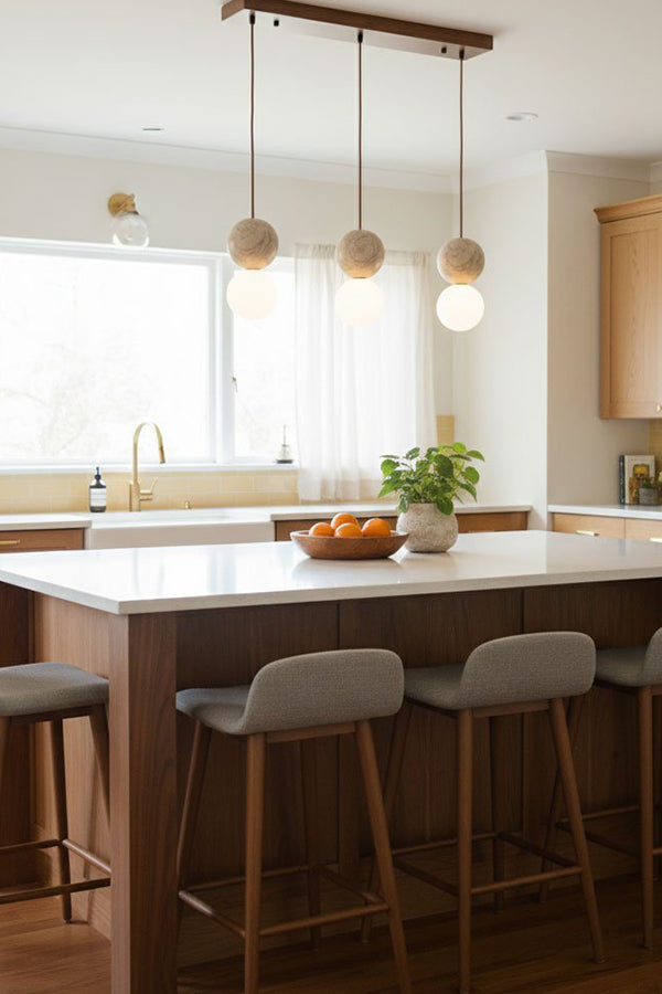 Linear travertine pendant lighting | Yellow Travertine, Glass | 3-light arrangement over a large kitchen island | vexa lamps