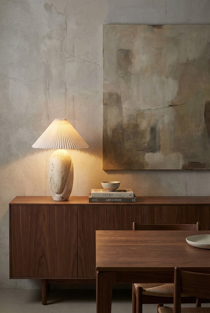 Modern organic stone table lamp | Travertine, Fabric | On a dark wood sideboard with abstract wall art | vexa lamps