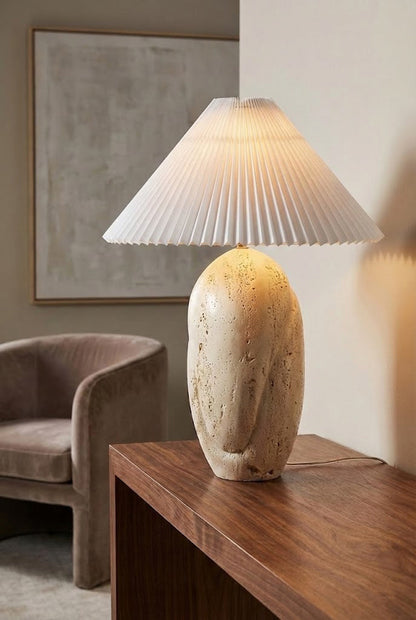 Lit travertine table lamp with warm glow | Travertine, Fabric | Side view on a wooden console table | vexa lamps