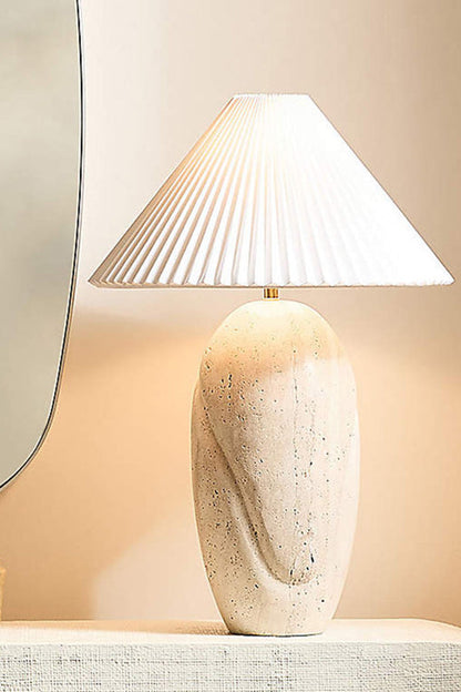 Detailed view of travertine table lamp | Travertine, Fabric | Close-up showing warm light and stone grain | vexa lamps
