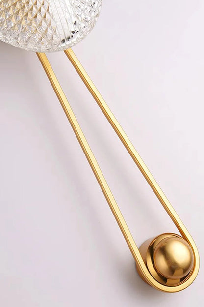 Vara Aura Woven Acrylic Wall Lamp | Woven Acrylic, Brass | Close-up detailed view of the elongated golden brass loop frame and round mounting fixture | vexa lamps