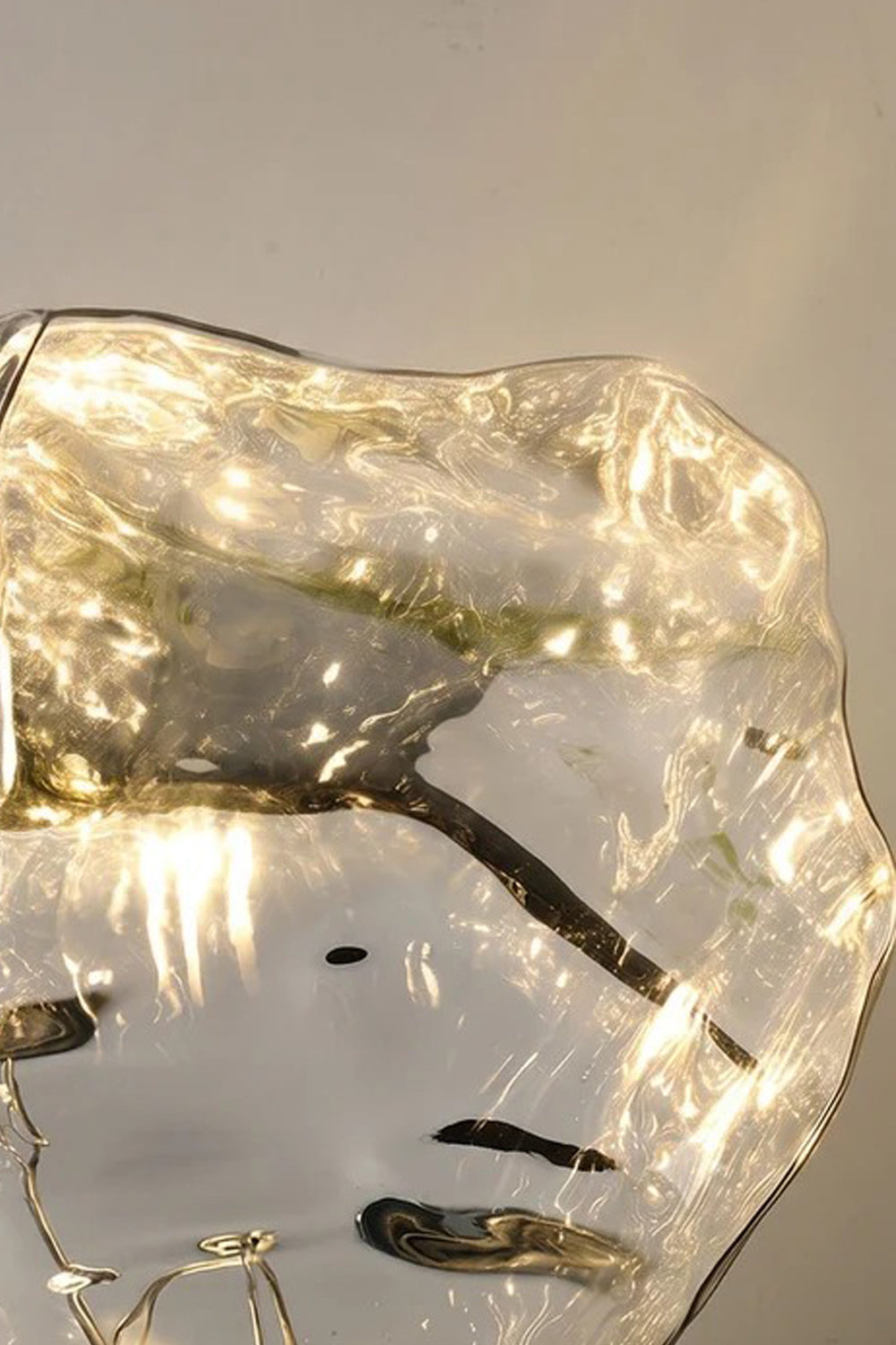 Vega Molten Metal Table Lamp with high-sheen metallic surface and organic curves reflecting light.