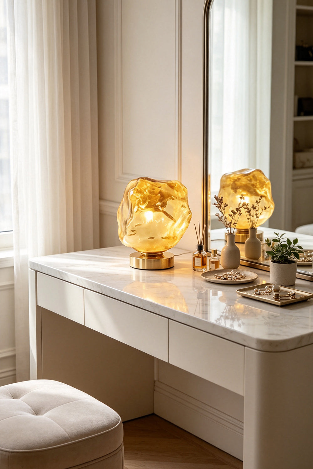 Vega Molten Metal Table Lamp on a modern desk, featuring a sculptural design with a golden hue, reflecting light beautifully.